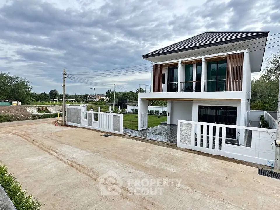 Modern two-story house with spacious driveway and landscaped garden in a serene neighborhood.