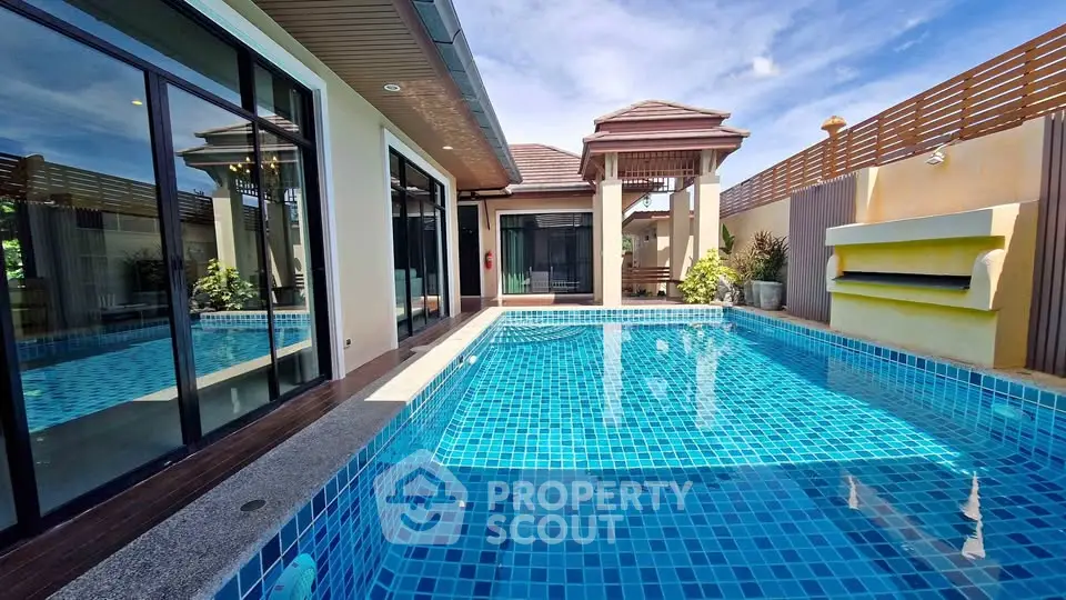 Luxurious villa with private pool and modern architecture under clear blue sky.