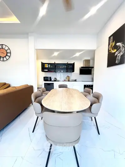 Modern open-plan kitchen and dining area with stylish decor and natural light.