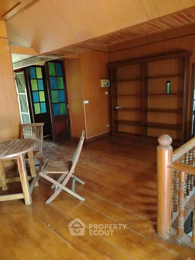 Charming wooden interior with rustic furniture and open shelving, perfect for cozy living.