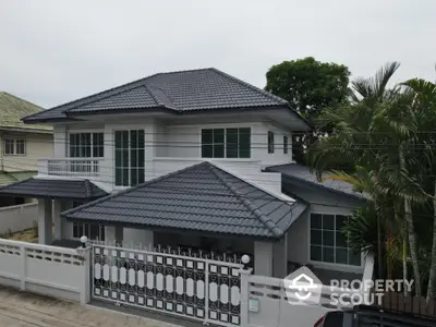 Elegant two-story house with modern design and spacious balcony in a serene neighborhood.