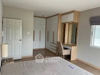 Spacious bedroom with modern built-in wardrobe and cozy study nook