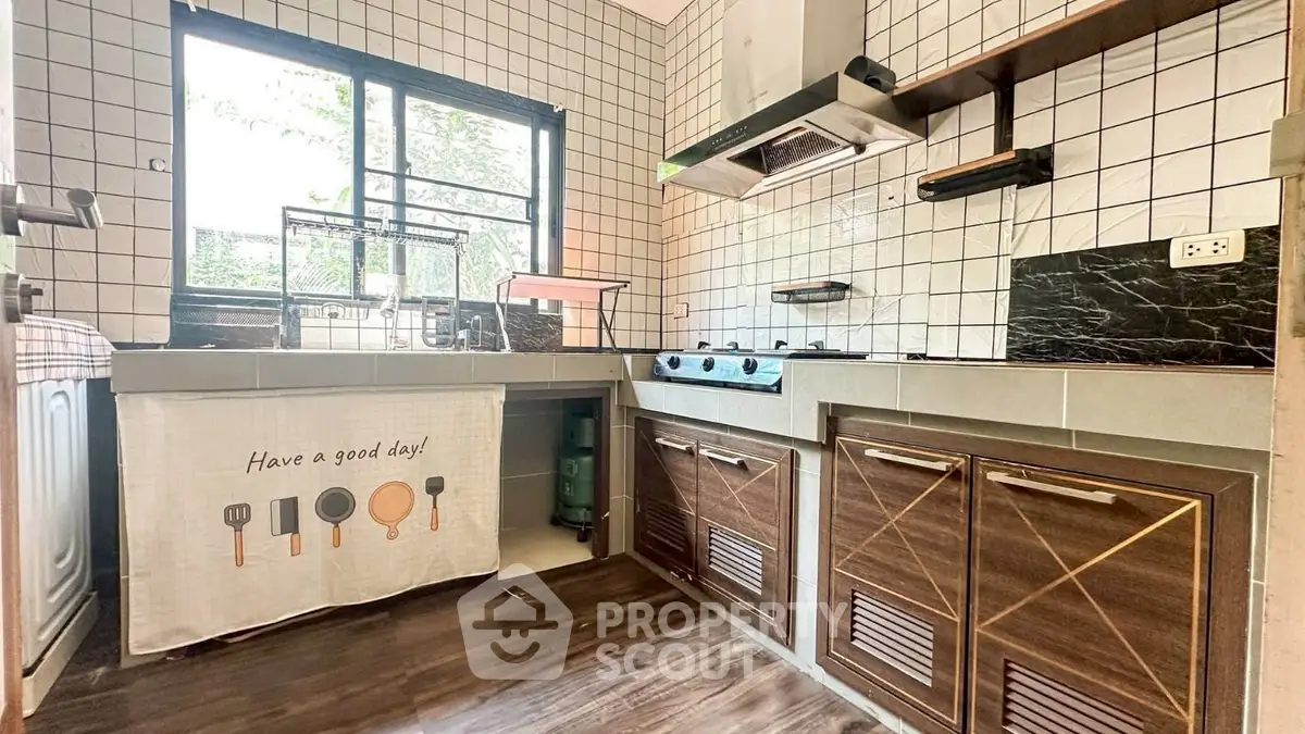 Charming kitchen with modern gas stove and stylish cabinetry, perfect for culinary enthusiasts.