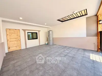 Spacious modern garage with tiled flooring and wooden accents, perfect for versatile use.