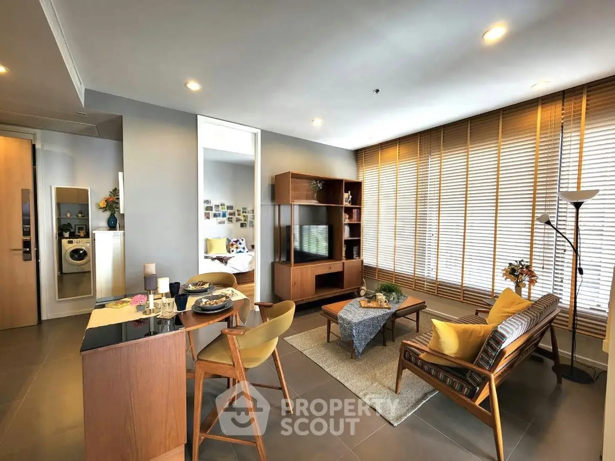 Modern living room with stylish furniture and natural light, perfect for relaxation and entertainment.