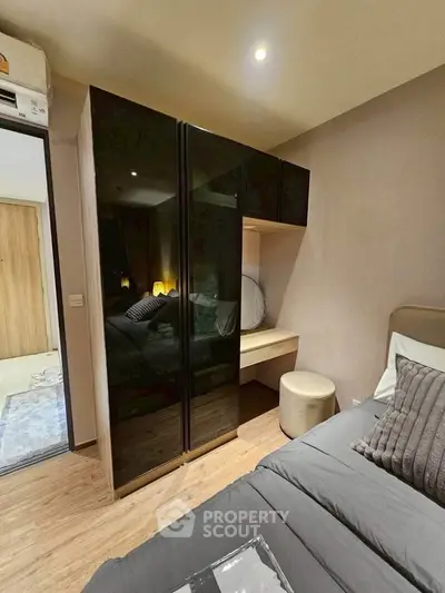 Modern bedroom with sleek black wardrobe and cozy decor