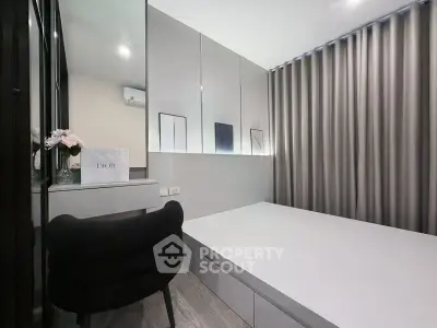 Modern bedroom with sleek design, mirrored walls, and elegant furnishings for a luxurious living experience.
