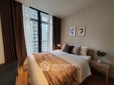 Cozy bedroom with large window and elegant decor in modern apartment