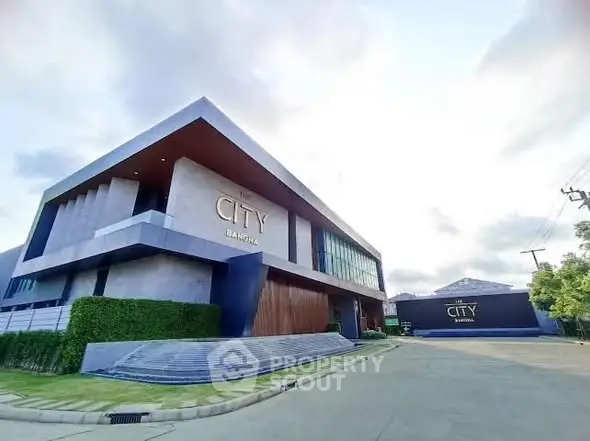 Modern architectural building with sleek design and lush greenery in a serene neighborhood.