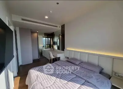 Modern bedroom with stylish decor and natural light in a contemporary apartment.