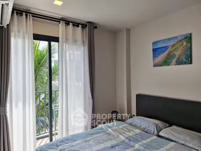 Cozy bedroom with balcony view and modern decor in a serene setting.