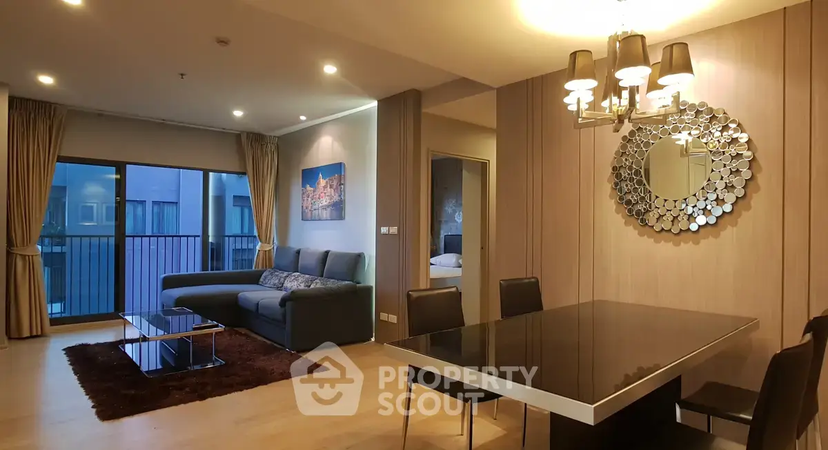 Spacious modern living room with elegant dining area and large windows in luxury apartment.