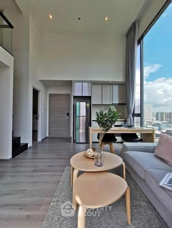 Modern living room with high ceilings and city view