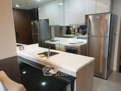 Modern kitchen with sleek appliances and stylish design in a contemporary apartment.