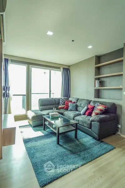 Spacious living room with modern decor and large windows offering natural light.