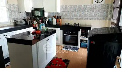 Charming kitchen with modern appliances and stylish tile backsplash