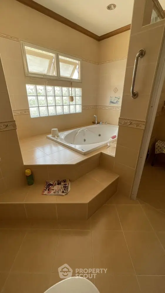 Luxurious bathroom with sunken bathtub and natural light