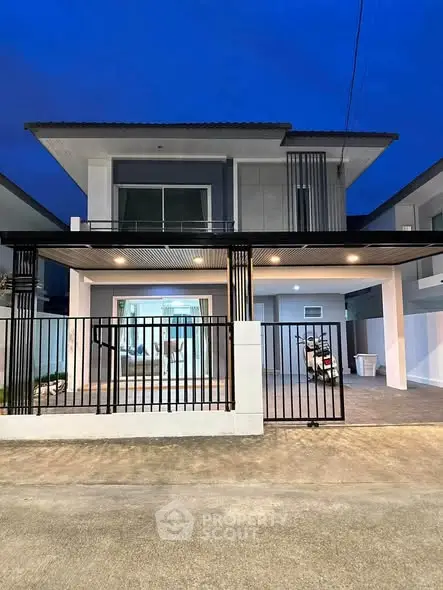 Modern two-story house with sleek design and spacious driveway at dusk.