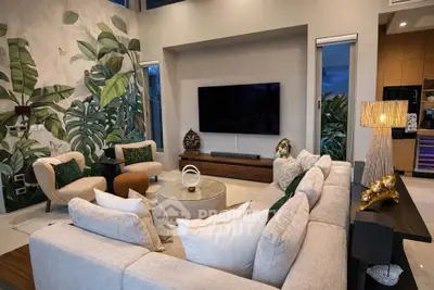Luxurious living room with modern decor and large TV, featuring elegant furniture and stylish wall art.