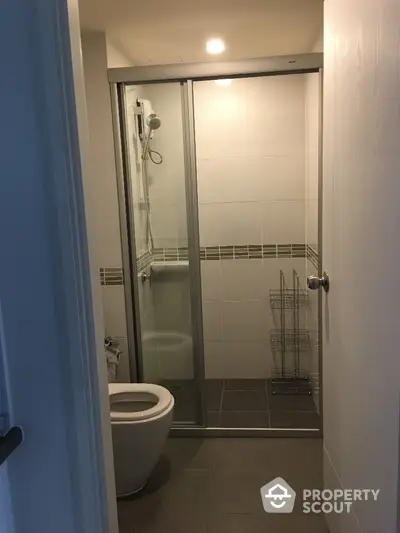 Modern bathroom with glass shower enclosure and sleek tile design