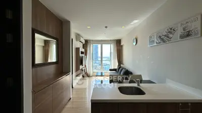 Modern living room with city view, featuring sleek furniture and stylish decor.