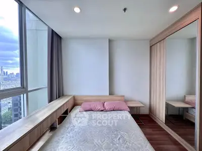 Modern bedroom with city view, featuring large windows and built-in wardrobe.