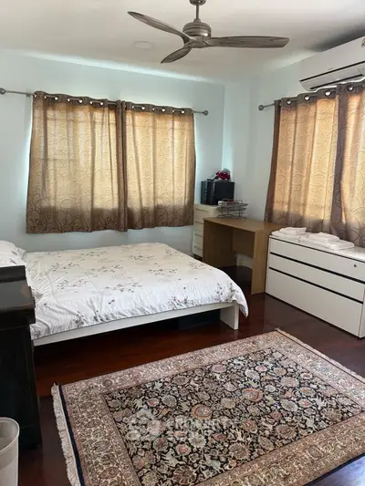 Spacious bedroom with elegant decor and natural light