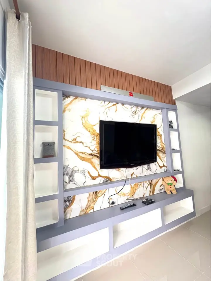 Modern living room with stylish TV wall unit and marble accents