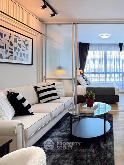 Modern living room with stylish decor and cozy bedroom view