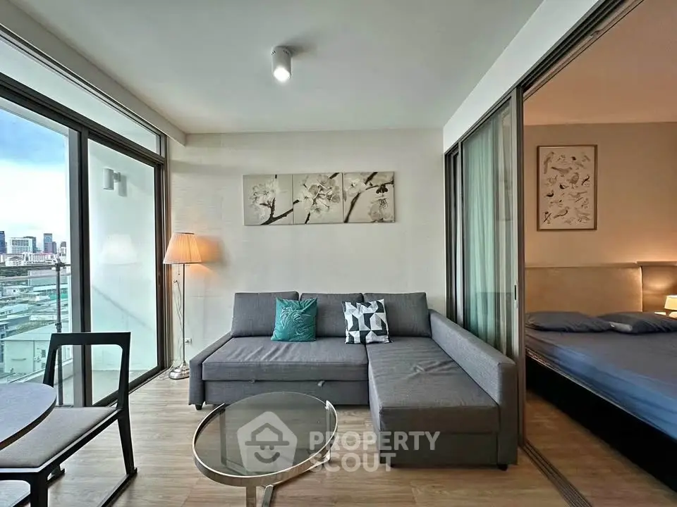 Modern living room with city view, featuring stylish furniture and elegant decor in a high-rise apartment.