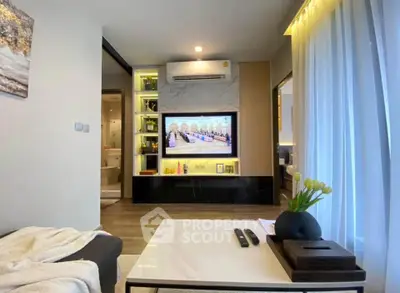Modern living room with sleek design, featuring a wall-mounted TV and elegant decor.