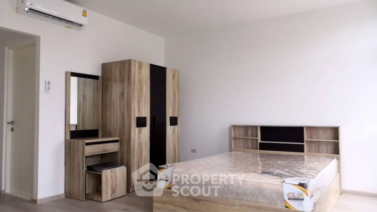 Modern bedroom with wooden furniture and air conditioning unit