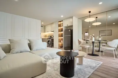 Modern open-plan living room with stylish furniture and integrated kitchen appliances.