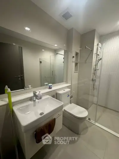 Modern bathroom with sleek fixtures and glass shower enclosure