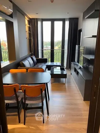 Modern living room with sleek furniture and large windows offering a scenic view.