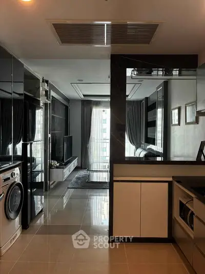 Modern apartment interior with sleek kitchen and spacious living area, featuring large windows and stylish decor.