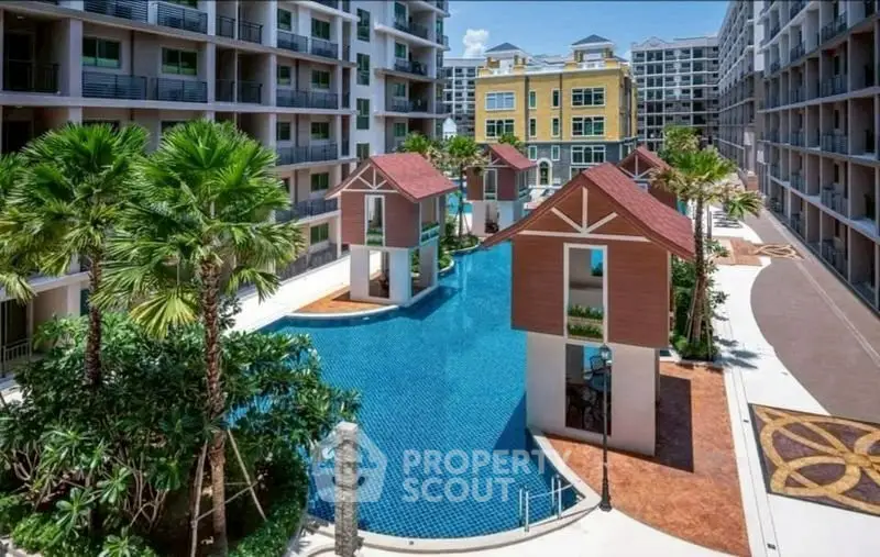 Luxurious resort-style apartment complex with stunning pool and tropical landscaping.