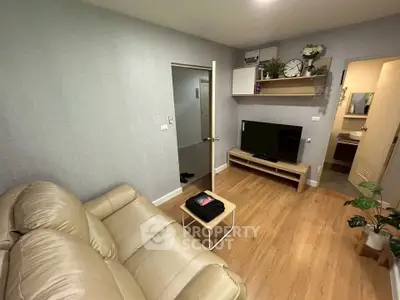 Cozy living room with modern decor and comfortable seating in a stylish apartment.