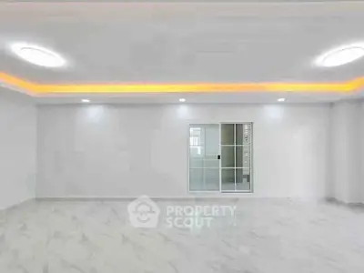 Spacious modern living room with sleek marble flooring and ambient lighting.