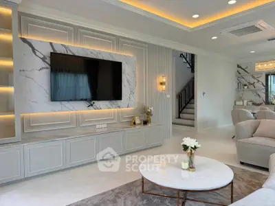 Luxurious living room with modern decor, marble accents, and ambient lighting, perfect for relaxation and entertainment.