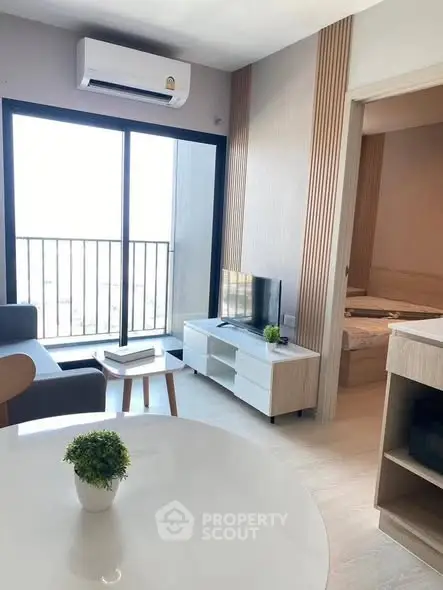 Modern living room with balcony access and stylish decor in a contemporary apartment.