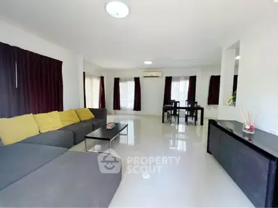 Spacious living room with modern furniture and ample natural light