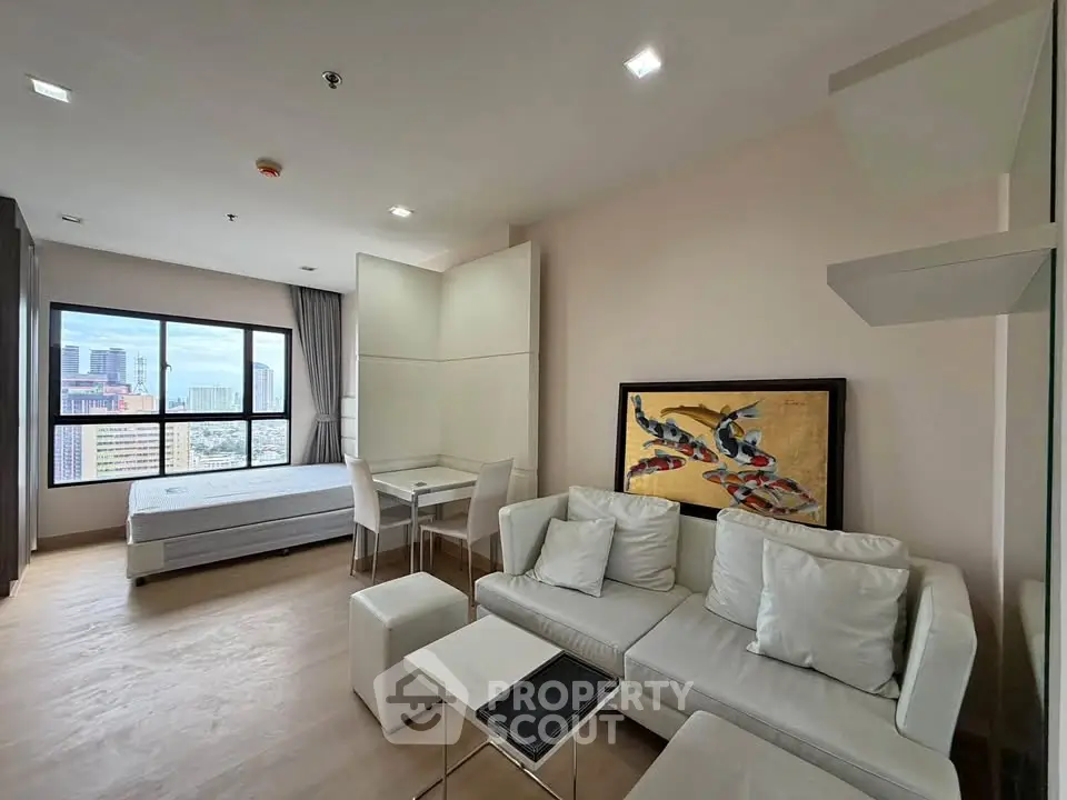 Modern studio apartment with city view, featuring a cozy living area and stylish decor.