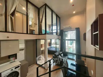 Modern loft apartment with mezzanine, large windows, and stylish interior design in urban setting.