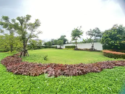 Spacious green garden with lush landscaping and vibrant foliage in a serene residential setting.