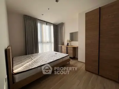 Spacious bedroom with wooden furniture and natural light