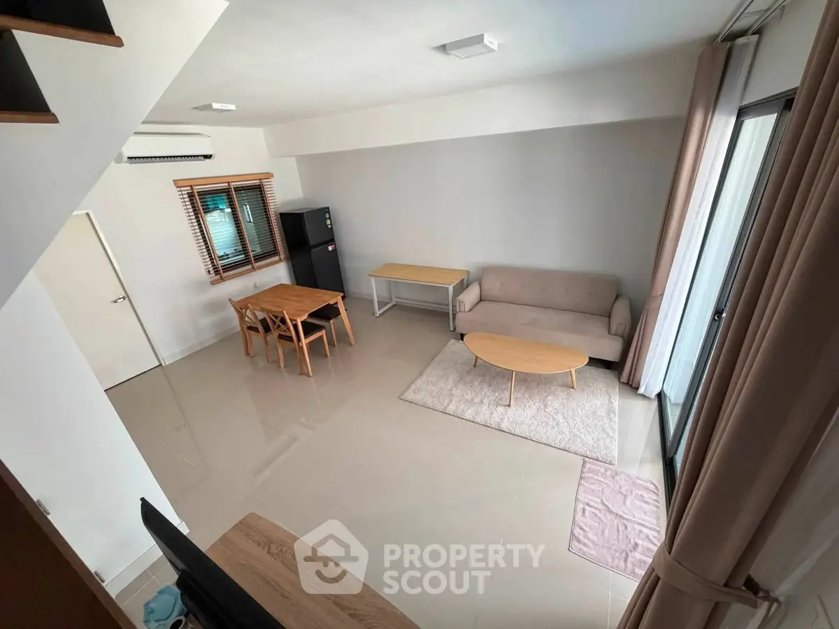 Spacious modern living room with minimalist furniture and large windows for natural light.