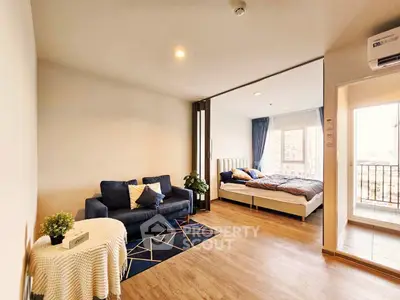 Modern open-plan living room with cozy bedroom and balcony view