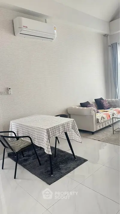 Modern living room with air conditioning and stylish furniture in a bright, open space.