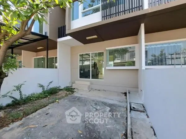 Modern townhouse exterior with private garden and large windows